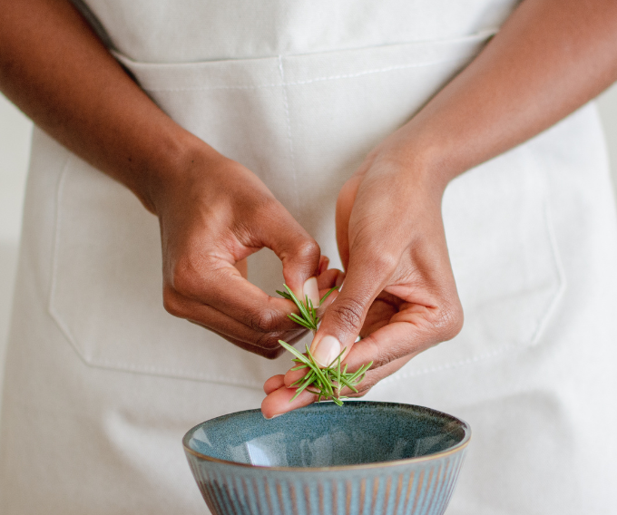 WSHC Cincinnati gut health woman preparing herbs into a bowl